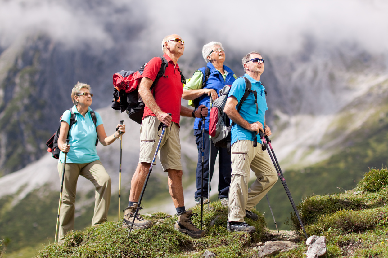active seniors on hike in austrian mountains